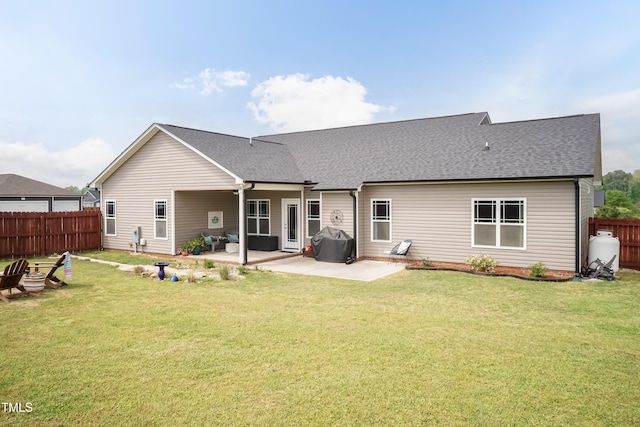 back of property featuring a patio and a shingled roof