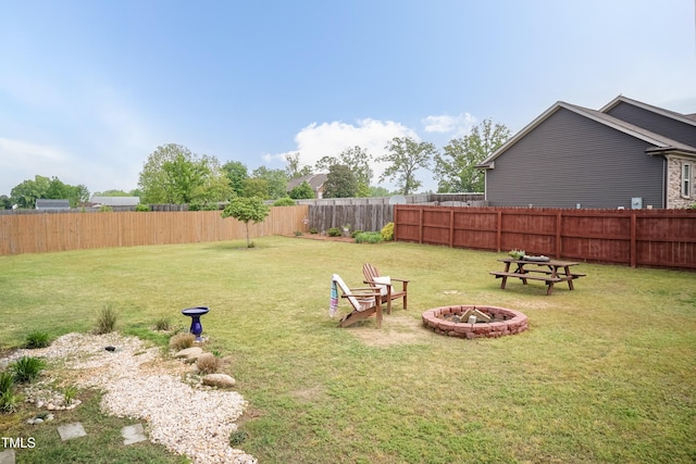 view of yard featuring an outdoor fire pit