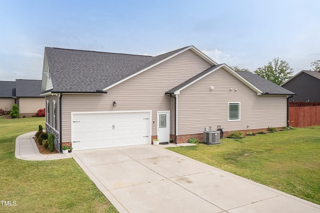 view of home's exterior with a shingled roof, concrete driveway, a yard, an attached garage, and central AC