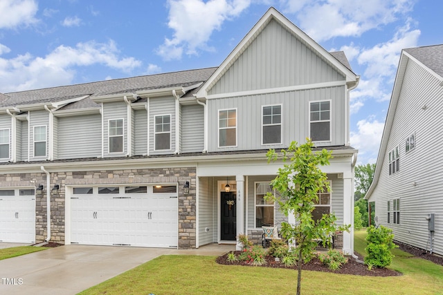 646 Shelford Trl, Zebulon, NC 27597 - view of property featuring board and batten siding, a porch, a front lawn, driveway, and a garage