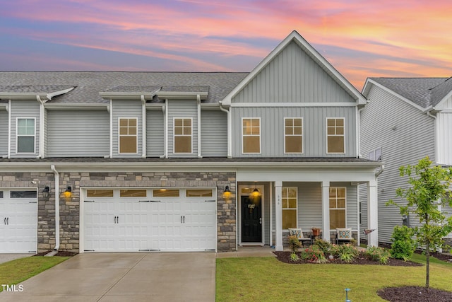 646 Shelford Trl, Zebulon, NC 27597 - townhome / multi-family property featuring a porch, driveway, a front lawn, board and batten siding, and a shingled roof