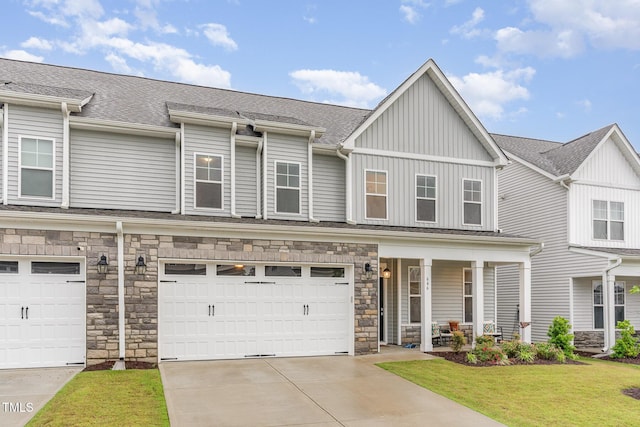 646 Shelford Trl, Zebulon, NC 27597 - townhome / multi-family property with a porch, a front lawn, board and batten siding, and an attached garage