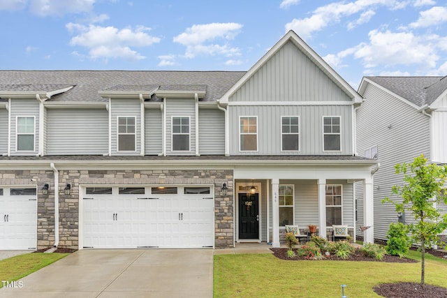 646 Shelford Trl, Zebulon, NC 27597 - view of property with covered porch, driveway, a front yard, board and batten siding, and roof with shingles