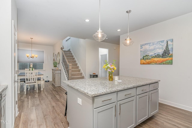646 Shelford Trl, Zebulon, NC 27597 - kitchen with light wood-style flooring, recessed lighting, a kitchen island, baseboards, and a chandelier