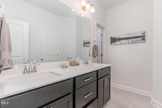 646 Shelford Trl, Zebulon, NC 27597 - bathroom featuring baseboards, double vanity, and tile patterned floors
