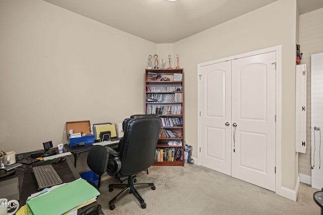 carpeted home office with baseboards
