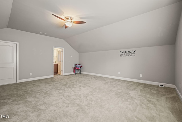 bonus room featuring lofted ceiling, a ceiling fan, carpet floors, and baseboards