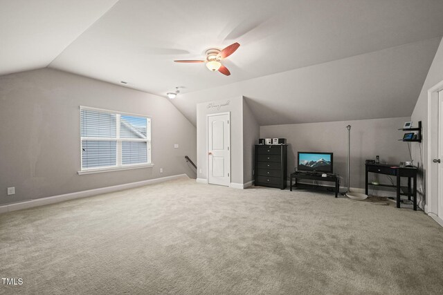 bonus room featuring lofted ceiling, carpet, ceiling fan, and baseboards