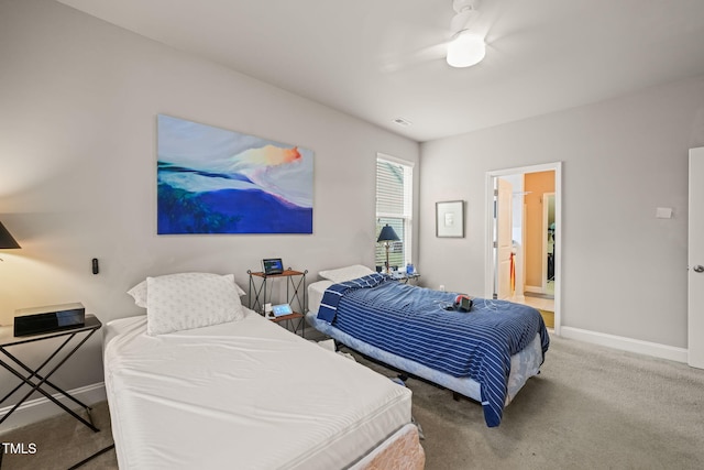 carpeted bedroom featuring baseboards, ceiling fan, and connected bathroom