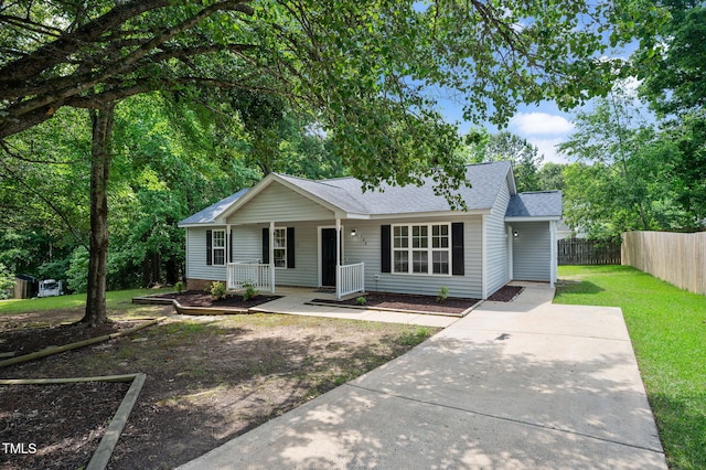 single story home with covered porch and roof with shingles