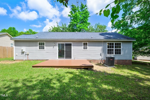 back of property featuring central AC unit, a deck, and a shingled roof