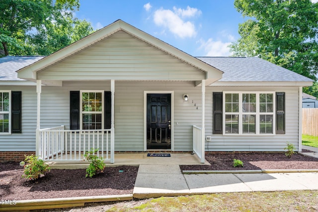 view of front of home featuring a porch and roof with shingles