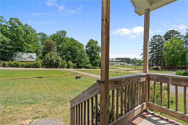 wooden deck featuring a lawn