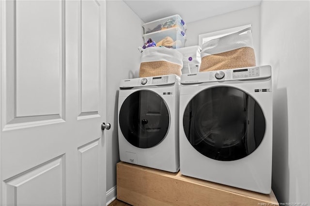 clothes washing area featuring separate washer and dryer
