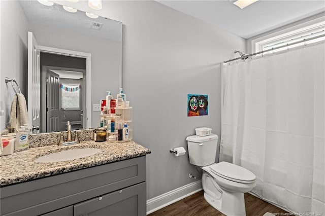 full bath with wood finished floors, toilet, vanity, and plenty of natural light