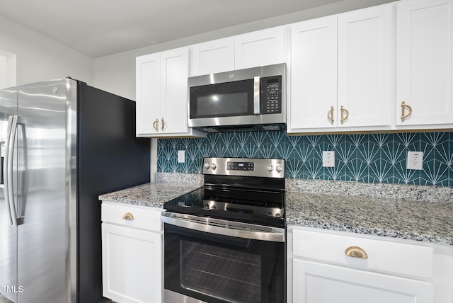kitchen with stainless steel appliances, tasteful backsplash, white cabinetry, and light stone countertops