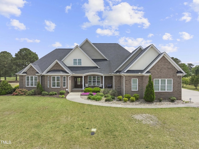 craftsman house featuring brick siding, a front lawn, a porch, and a shingled roof