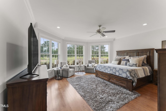 bedroom with ornamental molding, light wood finished floors, ceiling fan, and recessed lighting