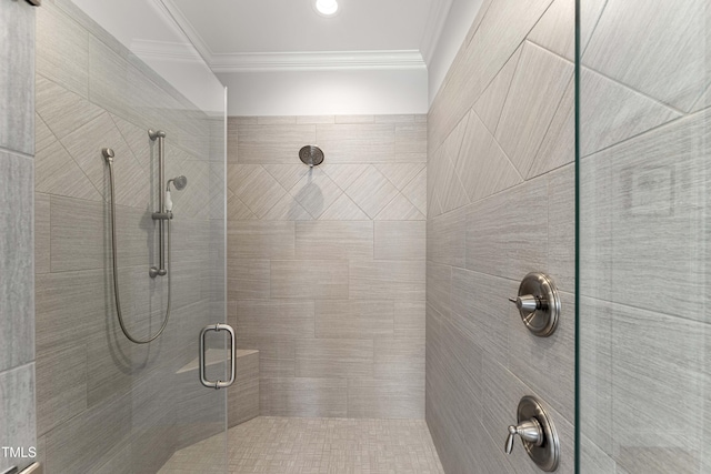 full bathroom with a stall shower and crown molding