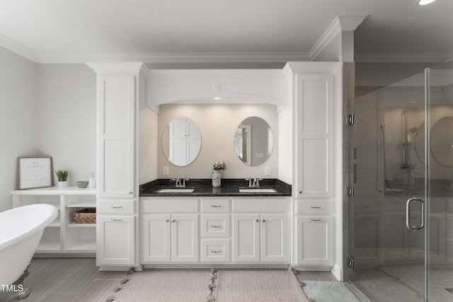 full bathroom with crown molding, a stall shower, double vanity, wood finished floors, and a freestanding bath