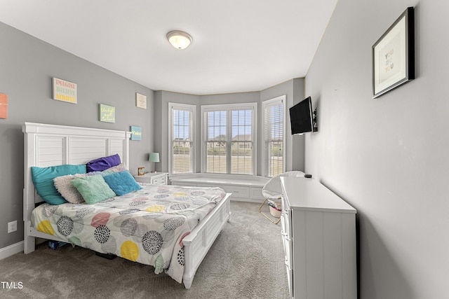 carpeted bedroom featuring baseboards