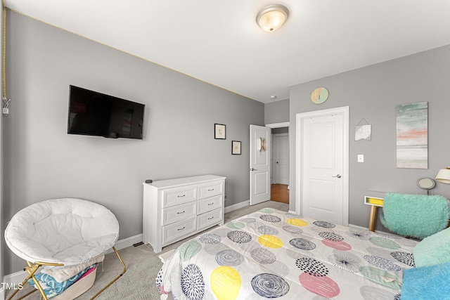 bedroom featuring baseboards and light carpet
