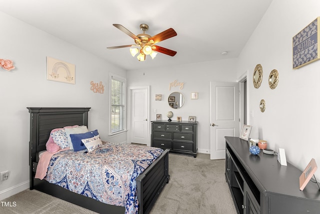 bedroom with light colored carpet, baseboards, and a ceiling fan