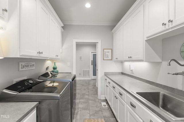 washroom with washing machine and dryer, crown molding, cabinet space, and recessed lighting
