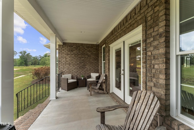 view of patio with french doors and a porch