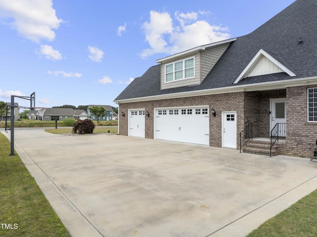 view of property exterior with concrete driveway, brick siding, and roof with shingles
