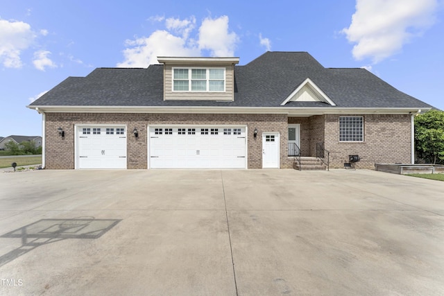 view of front of home with concrete driveway, brick siding, roof with shingles, and an attached garage