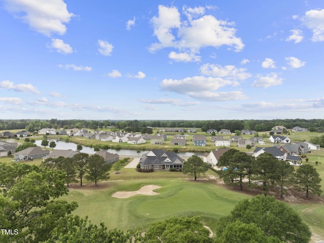 aerial perspective of suburban area with a local golf course and a large body of water