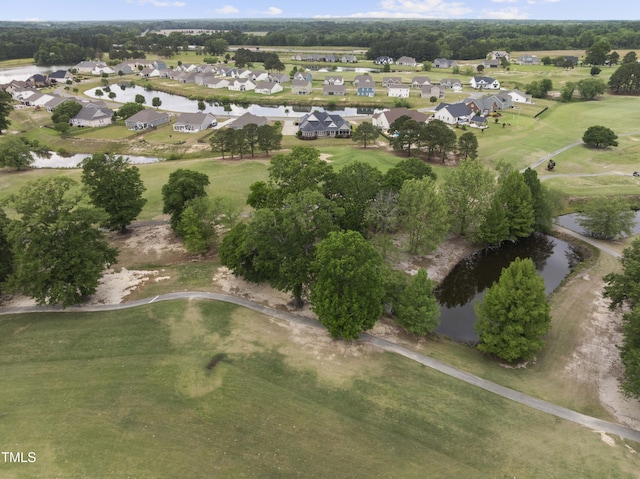 aerial view of property and surrounding area with nearby suburban area, a large body of water, and a local golf course