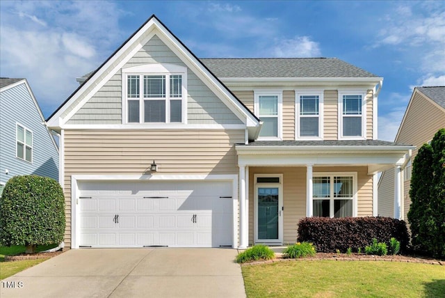 view of front of property with an attached garage, concrete driveway, and a front yard