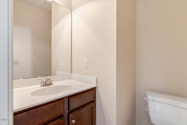 bathroom featuring toilet and vanity