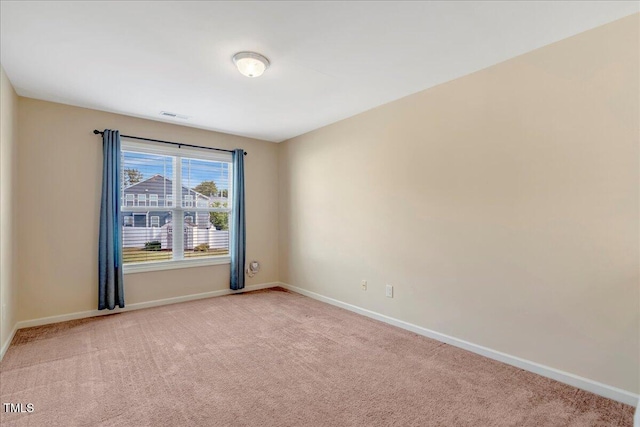 carpeted spare room with baseboards