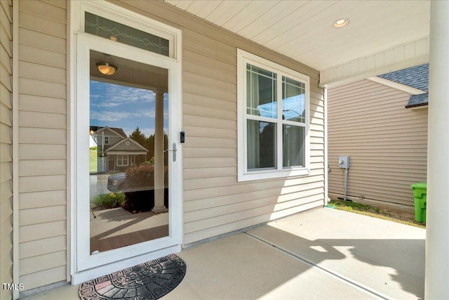 view of exterior entry featuring covered porch