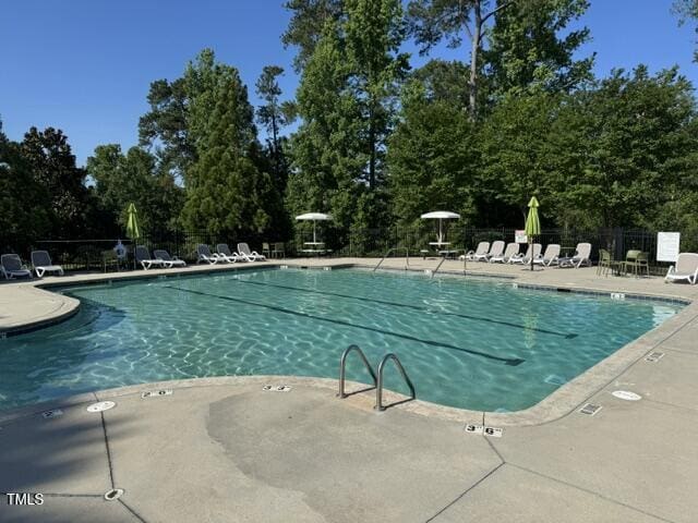 4109 Massey Preserve Trl, Raleigh, NC 27616 - community pool featuring a patio and view of wooded area