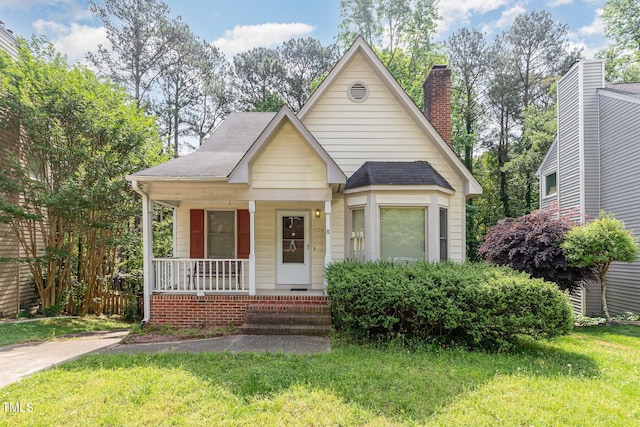 1720 Kingston Heath Way, Raleigh, NC 27604 - bungalow-style house with a porch, a front lawn, and roof with shingles