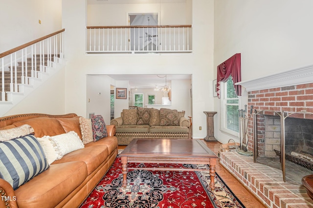 1720 Kingston Heath Way, Raleigh, NC 27604 - living room with a high ceiling, plenty of natural light, stairway, a fireplace, and wood finished floors