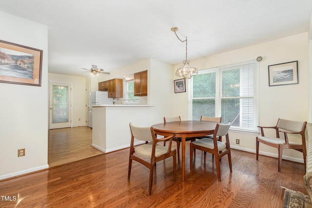 1720 Kingston Heath Way, Raleigh, NC 27604 - dining area featuring light wood-style flooring, a chandelier, baseboards, and ceiling fan