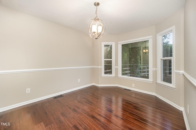 40 Crepe Myrtle Ct, Angier, NC 27501 - spare room with a chandelier, dark wood finished floors, baseboards, and a textured ceiling