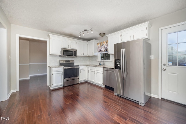 40 Crepe Myrtle Ct, Angier, NC 27501 - kitchen with appliances with stainless steel finishes, white cabinetry, tasteful backsplash, and a textured ceiling