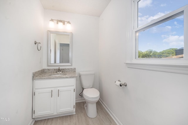 40 Crepe Myrtle Ct, Angier, NC 27501 - bathroom featuring toilet, wood finished floors, vanity, and baseboards