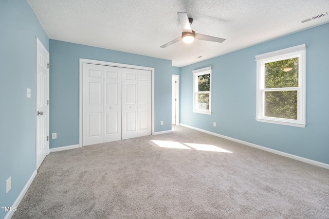 40 Crepe Myrtle Ct, Angier, NC 27501 - unfurnished bedroom featuring a textured ceiling, carpet, a closet, baseboards, and a ceiling fan