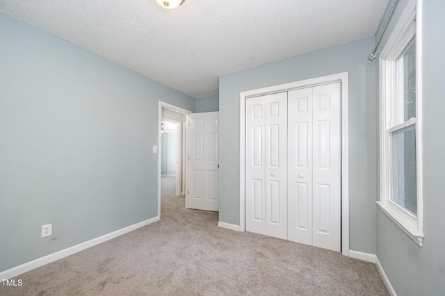 40 Crepe Myrtle Ct, Angier, NC 27501 - unfurnished bedroom featuring carpet flooring, a textured ceiling, a closet, and baseboards