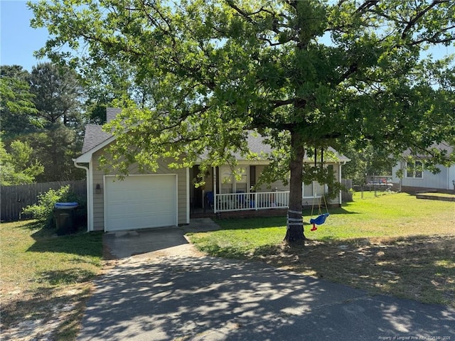 6651 Brookshire St, Fayetteville, NC 28314 - obstructed view of property with asphalt driveway, roof with shingles, covered porch, and a garage