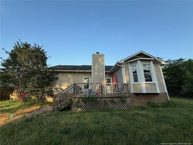 6651 Brookshire St, Fayetteville, NC 28314 - back of house featuring a wooden deck, a chimney, and a yard