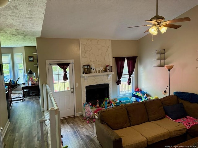 6651 Brookshire St, Fayetteville, NC 28314 - living area with healthy amount of natural light, wood finished floors, ceiling fan, a textured ceiling, and a stone fireplace