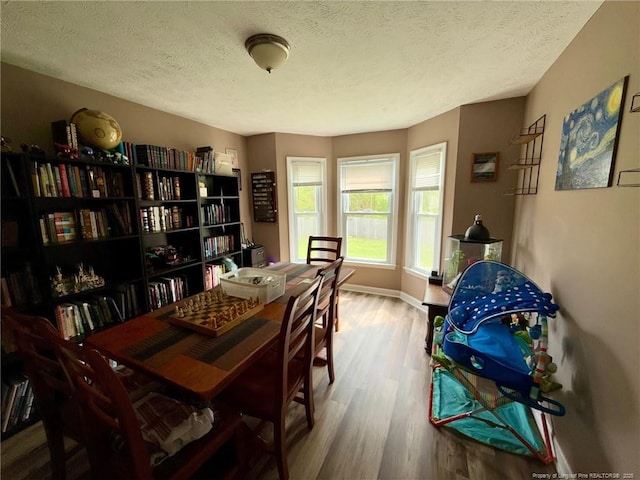 6651 Brookshire St, Fayetteville, NC 28314 - dining room featuring wood finished floors, a textured ceiling, and baseboards